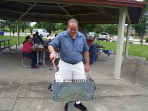 Grilling Hamburgers at the Picnic